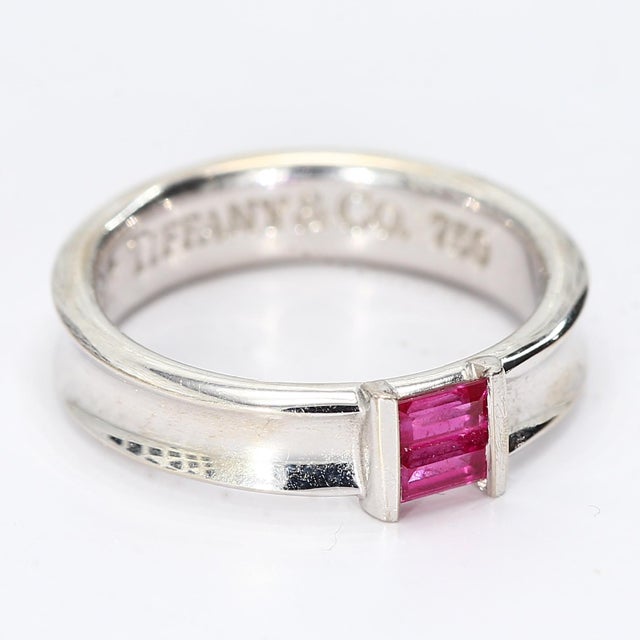 This classic Tiffany & Co. design is a timeless ring which also features two ruby baguettes. - Stone Info - 2x Ruby...
