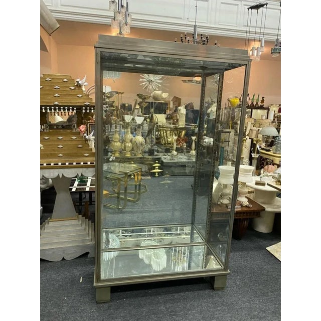 Stunning Modernist Art Deco Nickeled Bronze Showcase With Glass Door And Sides Designed in The 1920's-1930's.Fitted with...