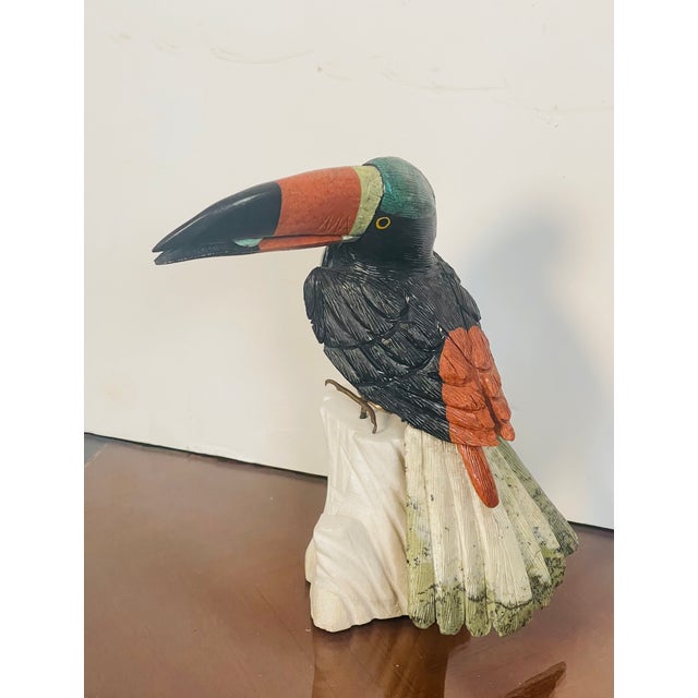 Impressive multi semiprecious stone carving toucan bird figurine on white marble stone pedestal.