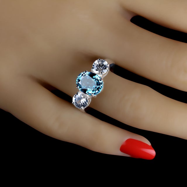 This is part of Chairish’s Fine Jewelry assortment. Stunning 4.25ct Oval Blue Zircon Ring with Round Side Stones Elevate...