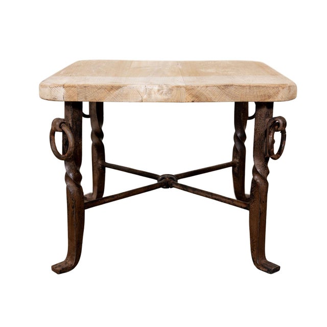 Small cocktail table. Twisted iron legs with iron rings. Bleached oak square top with clipped corners.