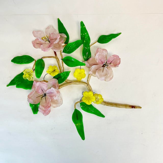 This is a Mid-Century decorative wall sculptural object. It features an acrylic and Lucite tree branch of cherry blossoms....
