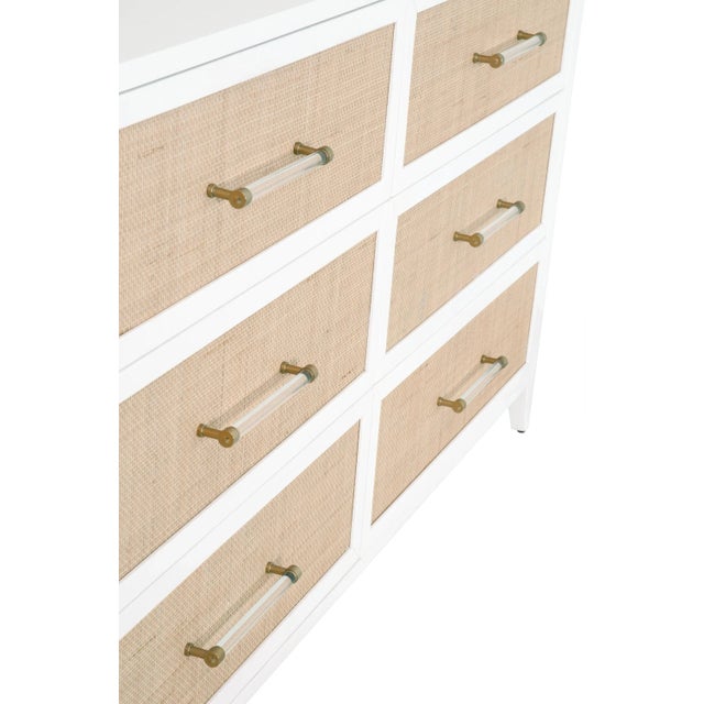 This transitional double dresser nicely blends design styles taken from tropical, traditional, and modern looks. The six...