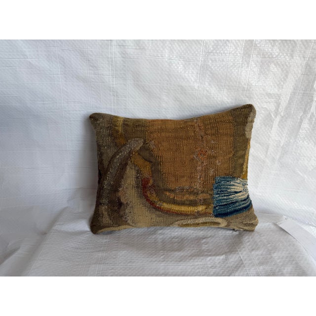 A distinctive decorative pillow created from a genuine 17th-century Brussels tapestry, this piece preserves an atmospheric...