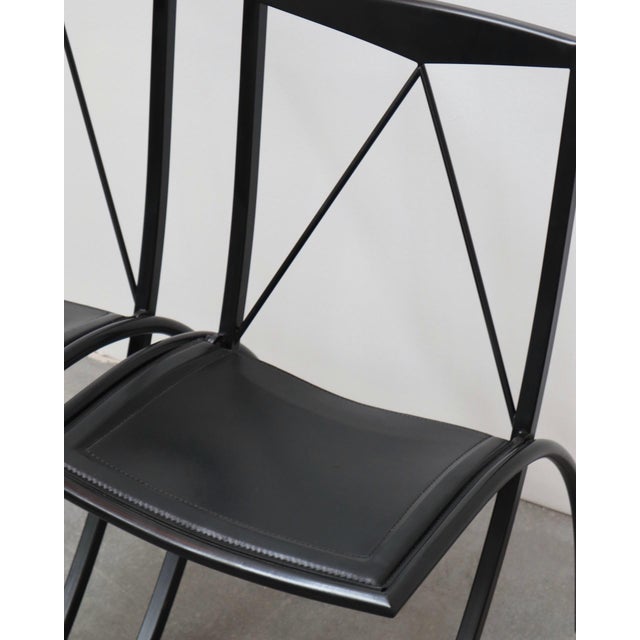 2 pairs available (4 chairs total). price is per pair. pair of 2 black folding chairs by the italian brand cattelan...