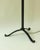 Large wrought iron floor lamp with a beautiful black patina, its tubular body adorned with four decorative reed-like...