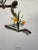 Catch My Drift I features a delicate arrangement of mixed media, combining organic forms with vibrant yellow daffodils....