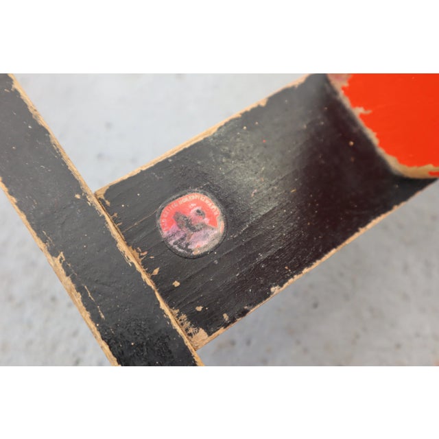 The wooden pole horse made in the 1950s. It has wipes and paint chips. Signature illegible.