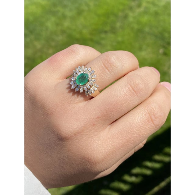 The Giron: Ladies 14K Emerald and Diamond Cluster Ring. Wonderfully crafted in 14 karat yellow gold is this vintage...