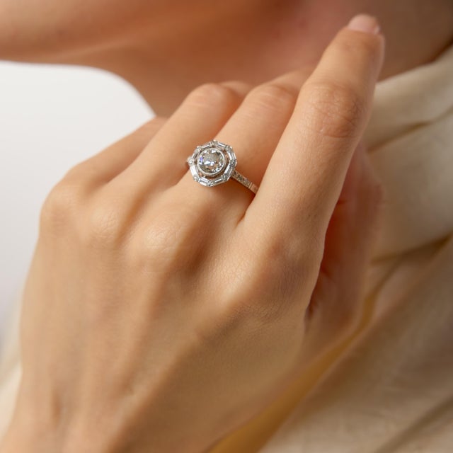 A refined interpretation of 1930s glamour, this Art Deco–inspired target ring centers on a luminous 1.13 carat old...