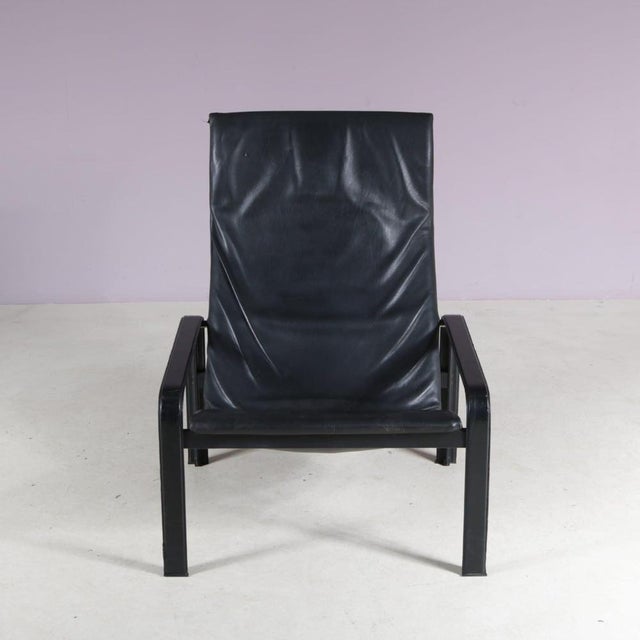 A beautiful black leather lounge chair manufactured by Matteo Grassi in Italy in the 1980s. This rare post-modern lounge...