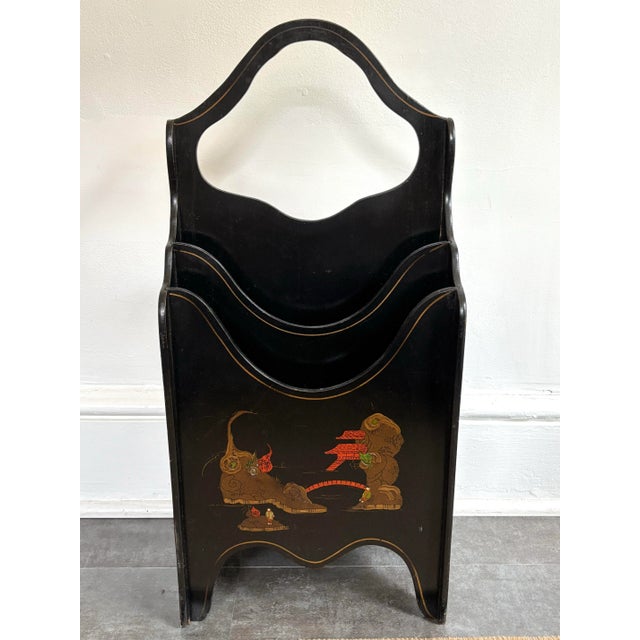1990s Chinoiserie four compartment magazine rack. Painted in a sleek black with decorative detailing on all four sides....