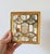 Vintage Hollywood Regency style double-toggle light switch plate cover. It features an ornate brass filigree grid inlaid...
