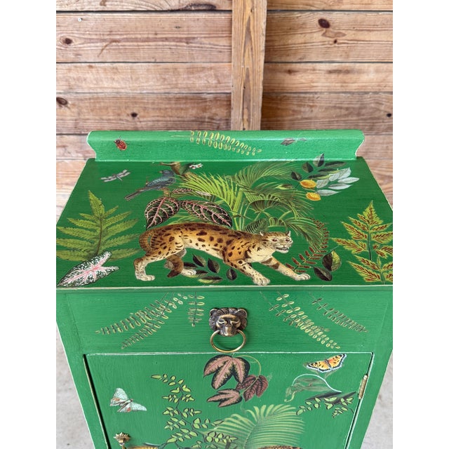 A one-of-a-kind custom painted and decoupaged tropical vintage cabinet featuring an extraordinary collection of jungle-...