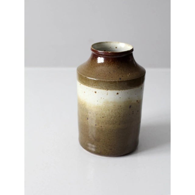 This vintage studio pottery vase is hand-crafted and signed by the artist. The organic form is finished with a beautifully...