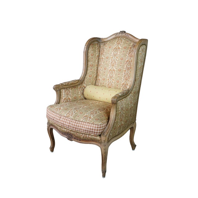This classic Louis XVI style wingback bergère is crafted from solid walnut, showcasing a beautifully carved exposed wooden...