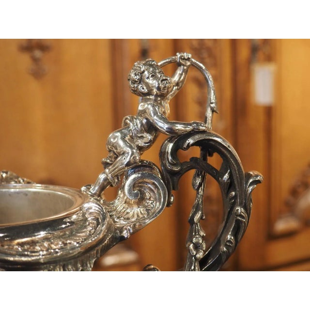 An exquisite example of Rococo style ornamentation, this antique (circa 1890) silvered bronze pitcher comes from France....