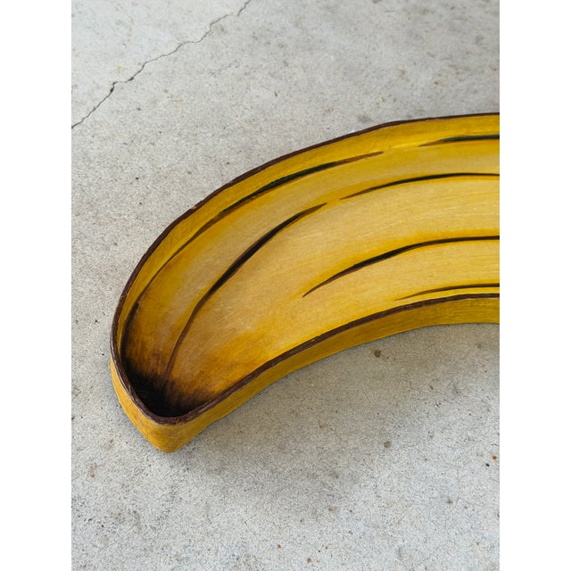 Add a healthy dose of tropical whimsy with this vintage hand-painted papier-mâché banana serving tray, handcrafted in...