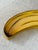 Add a healthy dose of tropical whimsy with this vintage hand-painted papier-mâché banana serving tray, handcrafted in...
