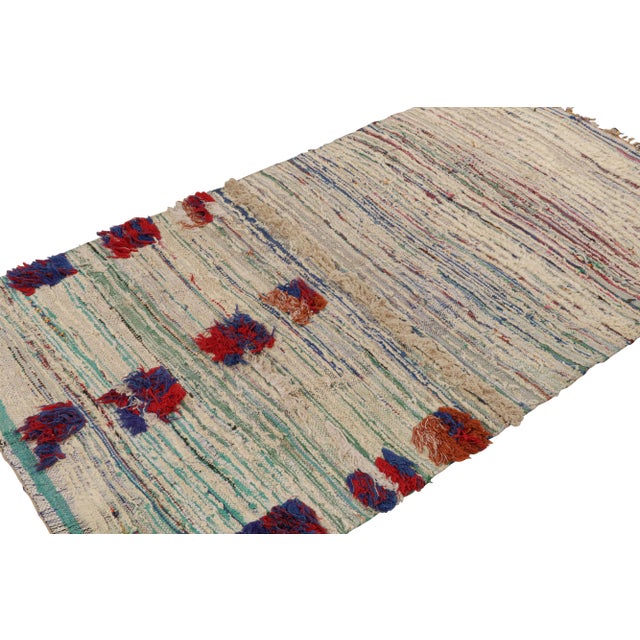 Hand-knotted in wool circa 1950-1960, this 4x7 vintage Moroccan rug with polychromatic geometric stripes, hails from the...