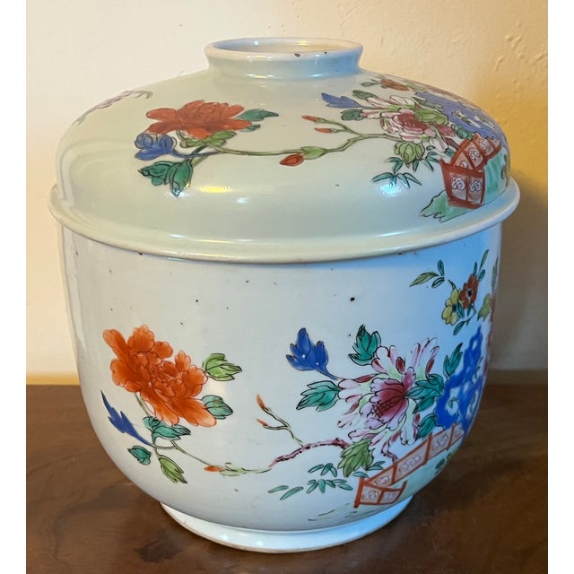 Antique 19th century Chinese export porcelain jar and cover in famille rose glaze. Decorated with peonies, rock work and a...