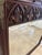 A striking statement piece, this grand wall mirror features an architectural frame with intricate Gothic tracery and...