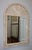 1990's mid-century modern arched tesselatted stone wall mirror with brass detail in the style of Maitland Smith, in...