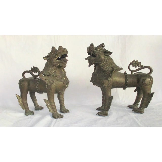 Antique bronze Buddhist lions from Nepal circa mid-late 18th century. Lost wax bronze lions cast in two sections,...