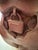 A hand‑carved wooden sculpture depicting a stylized female torso, rendered in rich, warm wood tones with smooth contours...