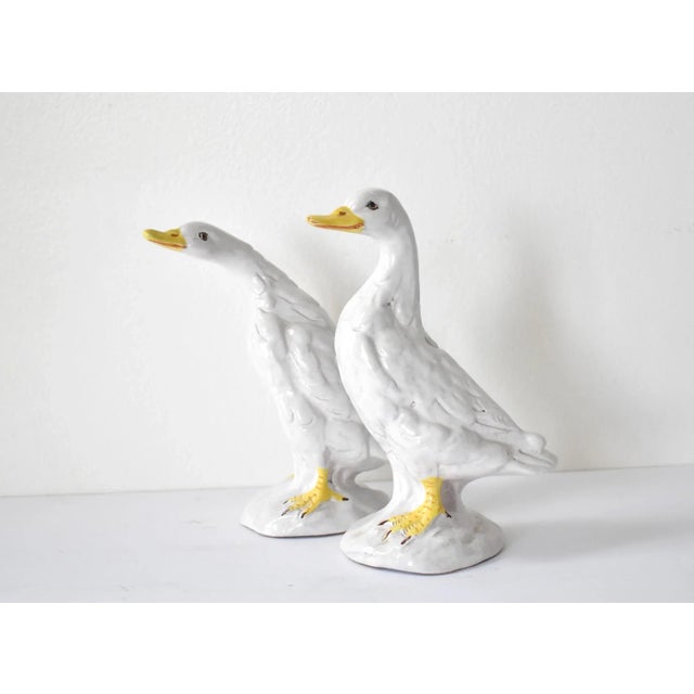 A pair of geese figurines in French faience by the Poterie de Bavent in France. Tin-glazed in white, brown, and yellow....