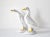 A pair of geese figurines in French faience by the Poterie de Bavent in France. Tin-glazed in white, brown, and yellow....