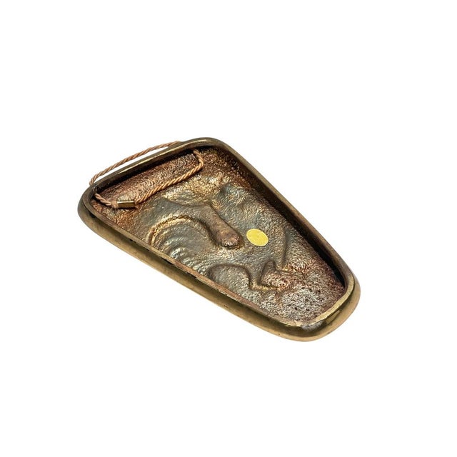 Charming and characterful mid-century wall relief in brass, featuring a stylized rooster motif. Made in West Germany, this...