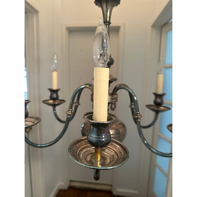 Vintage, six arm Colonial, Silver-Plated Chandelier with 6 candlabra bulbs, hardwired to 120 volts. Silver-plating has a...