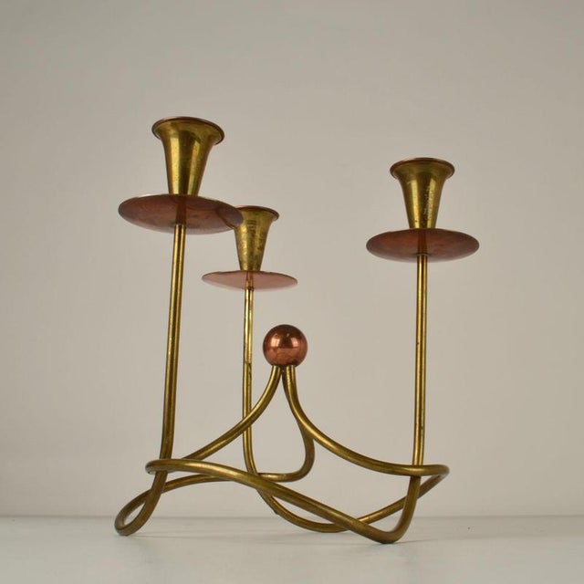 Mid Century free form copper and brass candelabra by Gunar Ander is elegant. It has three arms is suitable for regular...