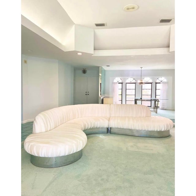 Serpentine sectional sofa with chrome plinth base by Milo Baughman for Thayer Coggin. Upholstered in a neutral, off-white...