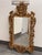 Design Plus Gallery presents an English Chippendale Carved Giltwood Mirror, Mid 20th Century. The mirror has a carved wood...