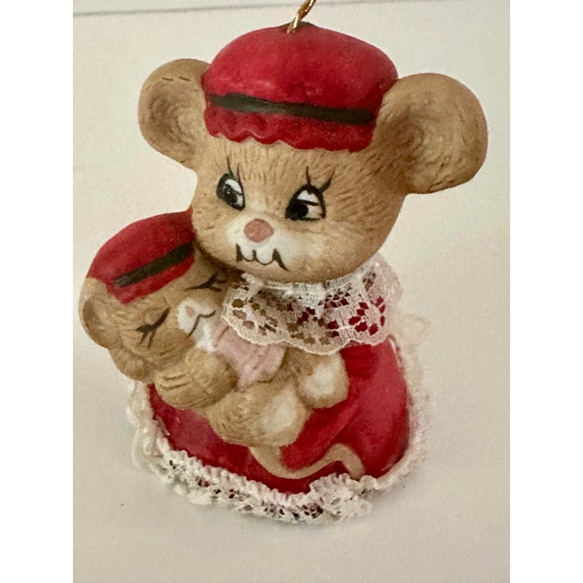 Vintage mother mouse holding a baby mouse Christmas tree bell ornament. Clacker is mouse legs. Bisque porcelain.