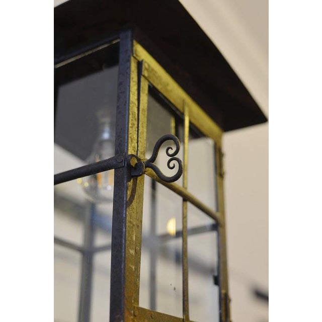 A very smart Arts & Crafts wrought iron hall lantern, of riveted construction with a roof, a door on on side with a heart...