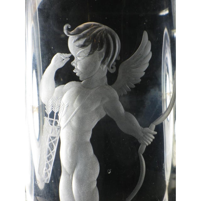 The product is a 6" engraved Swedish crystal vase featuring a naked cherub or cupid boy design. Made by Kjellander, this...