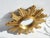 Vintage small sunburst mirror made out of resin with a shinny gold paint. It has beautiful golden asymmetric sunrays and a...