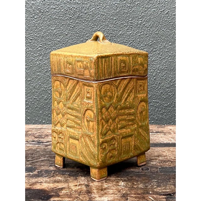 This vintage textured ceramic lidded box combines sculptural presence with practical storage. Dating to the mid-20th...