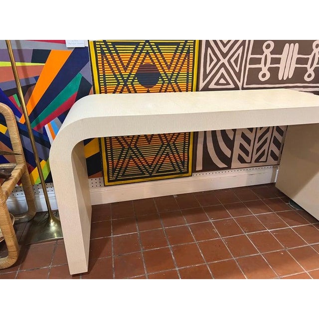1980's Off White Laminate Waterfall Console Table. Classic Post Modern style in excellent condition. Perfect for an entry...