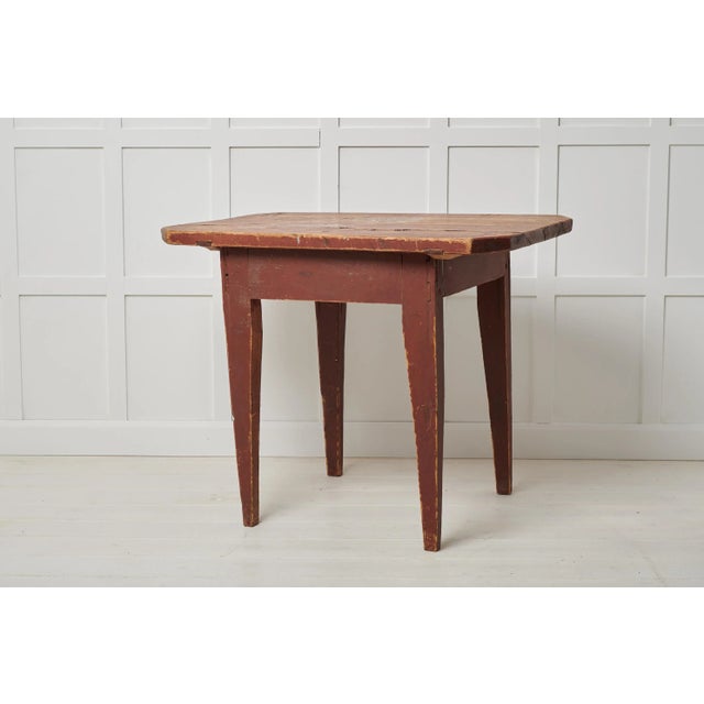 Antique Swedish primitive table in folk art. The table is a country furniture with a simple construction and a charmingly...