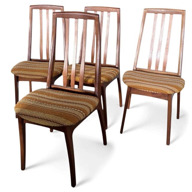 This set of mid century dining chairs features four Nathan high back teak chairs designed to bring authentic British mid-...