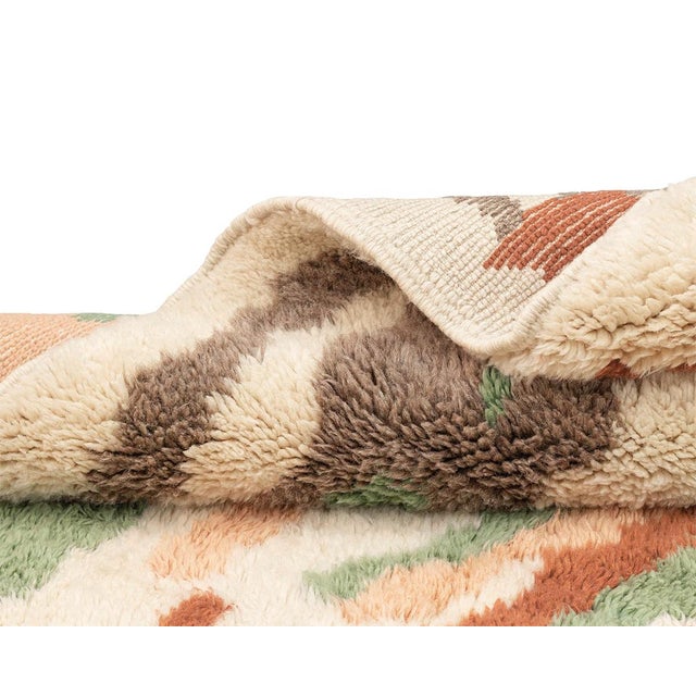 Vibrant hand-knotted wool rug with a lively mix of Mineral Green, Peach, Deep Taupe, and Umber vertical streaks on an...