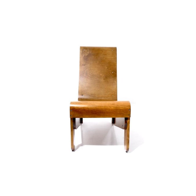 The armchair, with its steam-bent birch plywood seat and solid spruce base, strongly resembles Gerrit Rietveld's famous...