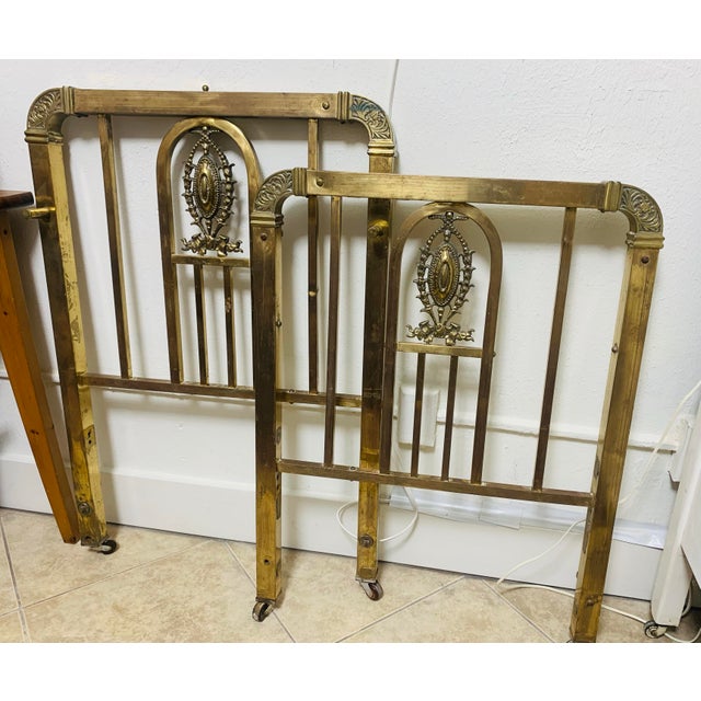 Beautiful pair of antique solid brass bed headboards featuring ornate Victorian-style cast medallions and decorative...