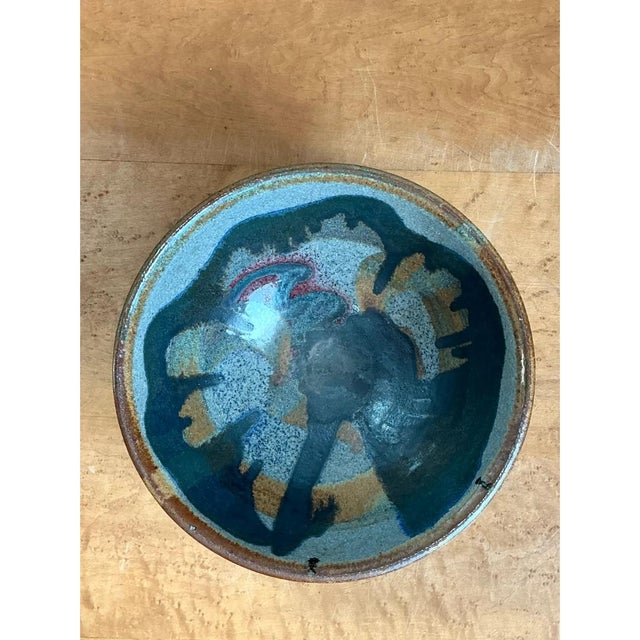 This vintage mid-century ceramic bowl demonstrates exceptional studio pottery craftsmanship, characterized by a classic...