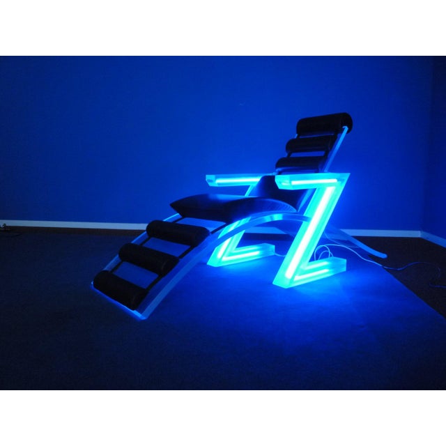 Extravagant acrylic glass lounge chair from the 1960s. Neon tubes are integrated into the armrests; they glow blue and are...