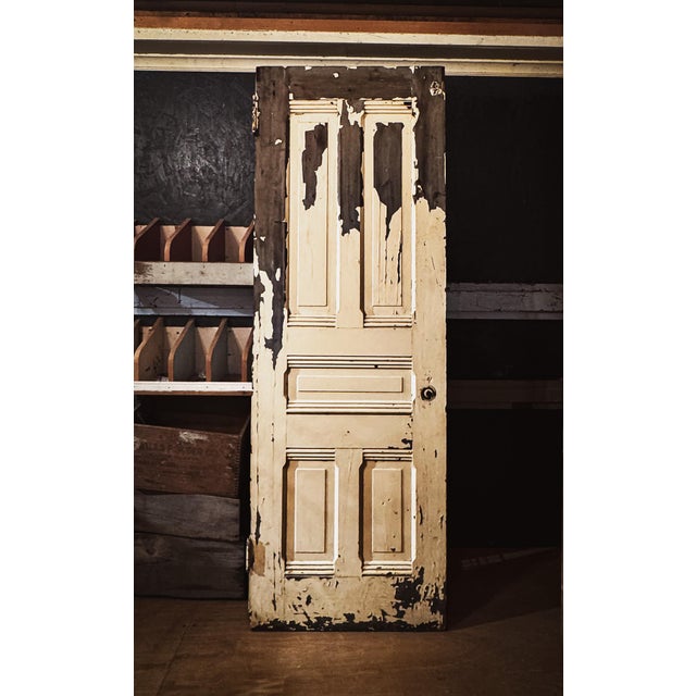 A sturdy Victorian-era five-panel door with handsome, shapely detail and character.